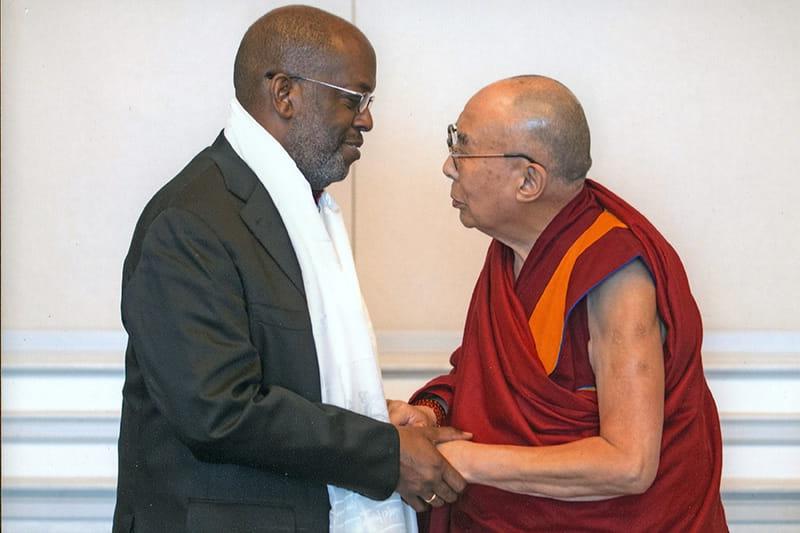 Bernard J Tyson shaking hands with the Dalai Lama
