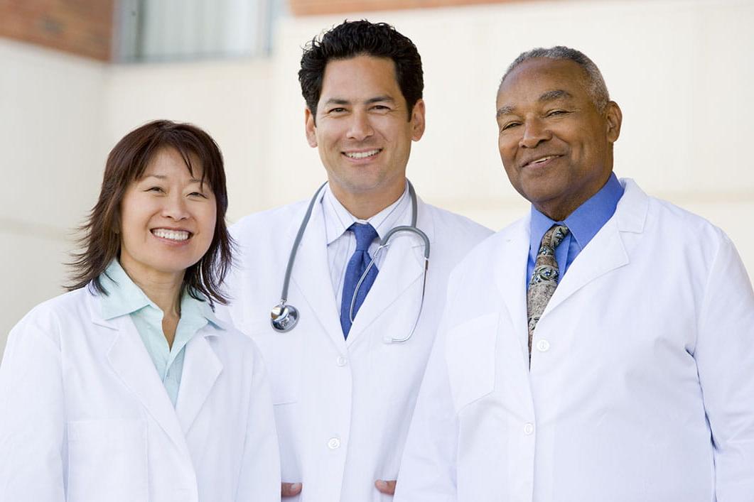 Three doctors smiling