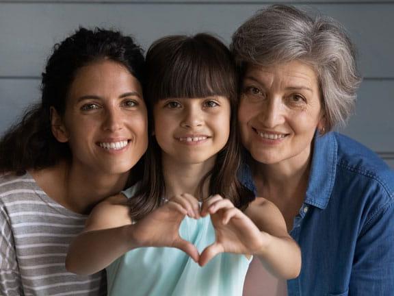 family of women close up making heart hands